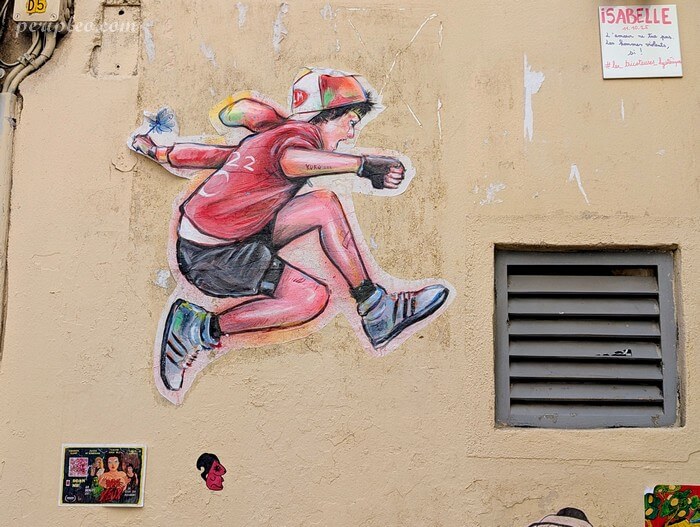Street art Rue du Four des Flammes à Montpellier avec collage d’un jeune personnage en mouvement dans le centre historique sud