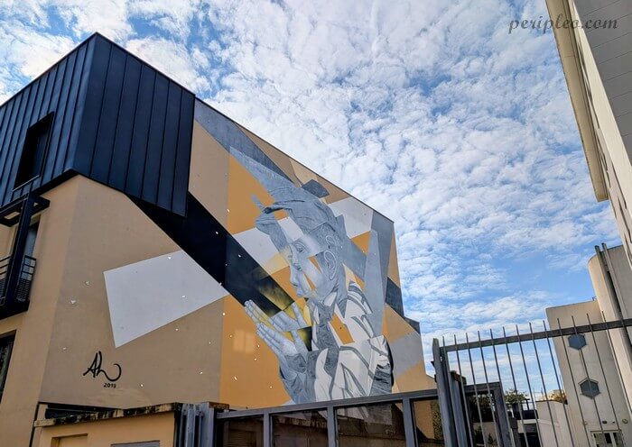 Street art Rue de la Méditerranée à Montpellier, fresque monumentale d’AL représentant un enfant sur une façade du Quartier Méditerranée