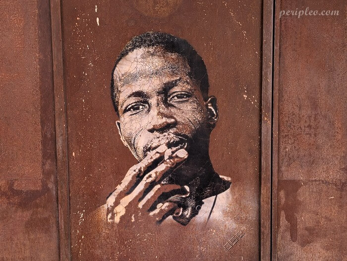 Street art Rue Pralon à Montpellier, portrait réaliste d’un homme réalisé au pochoir sur une façade du Quartier Méditerranée