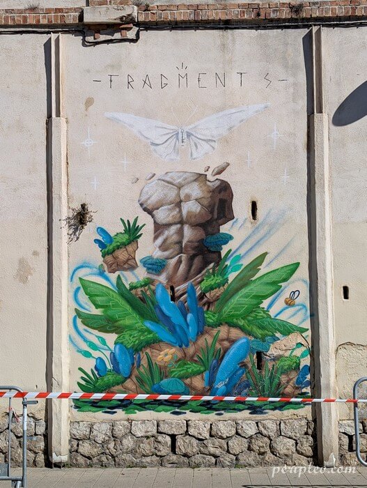 Fresque Fragments d’Alexandre Froment sur le Boulevard de Strasbourg à Montpellier représentant un torse sculpté entouré de végétation luxuriante et d’un papillon blanc
