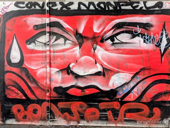 Fresque street art sous le Pont de Sète à Montpellier, portrait urbain rouge et noir au style graffiti