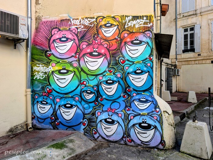 Street art Rue Rhin et Danube à Montpellier avec fresque colorée de personnages souriants Kool Kidz dans le centre historique sud