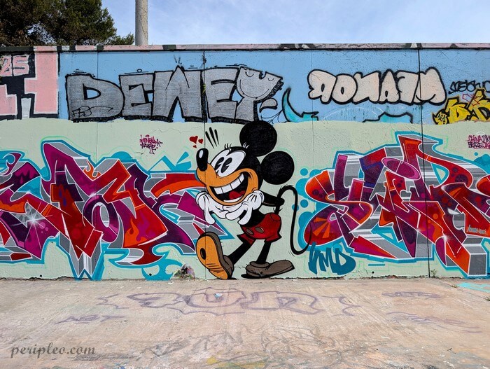 Street art représentant Mickey entouré de graffitis colorés sur les murs du Quai du Verdanson, spot incontournable de Montpellier